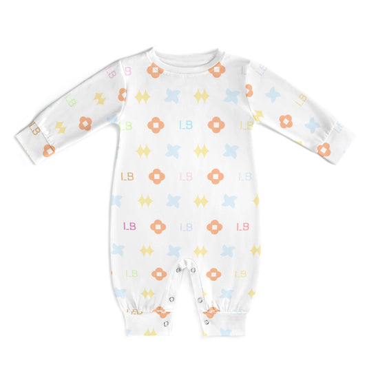 White baby onesie with colorful floral and letter patterns, featuring snaps at the legs.