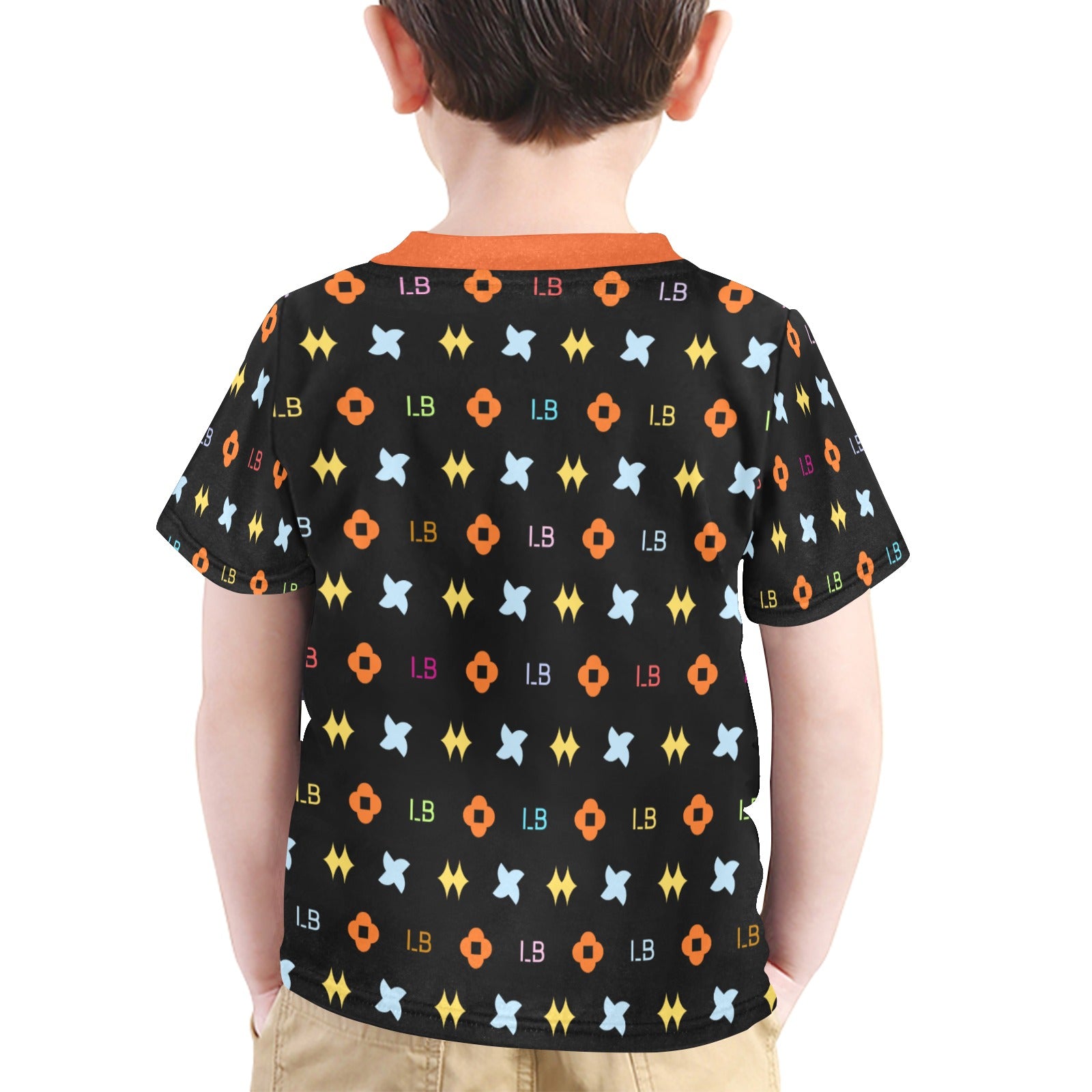 Boy in a black shirt with colorful geometric patterns and an orange collar, beige pants.