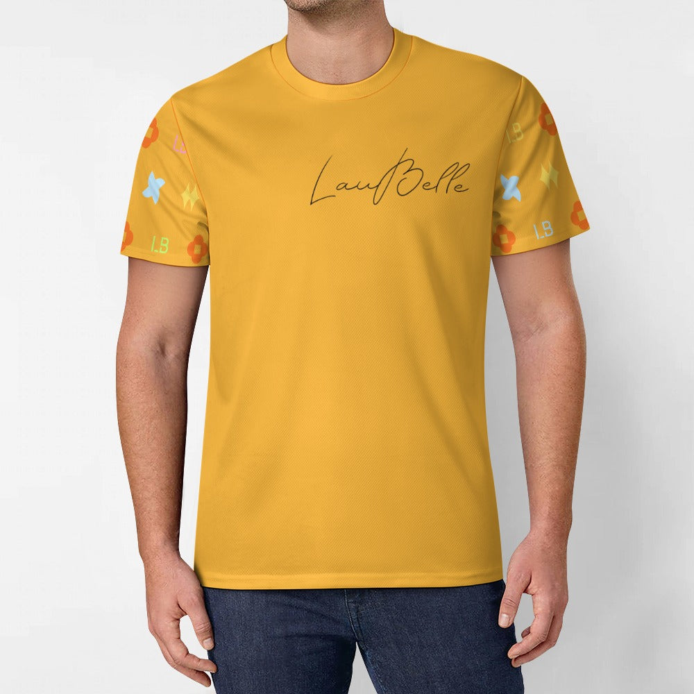Man in mustard yellow T-shirt with script logo and colorful geometric pattern on sleeves
