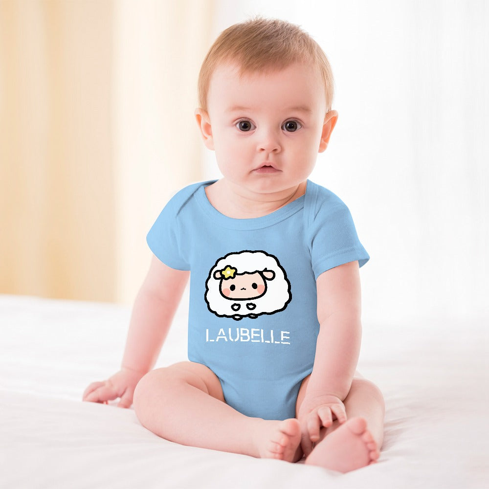 Baby in a blue onesie with a cartoon sheep design sits on a white blanket.