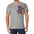 Man in light gray T-shirt with colorful patchwork bear graphic and patterned short sleeves.