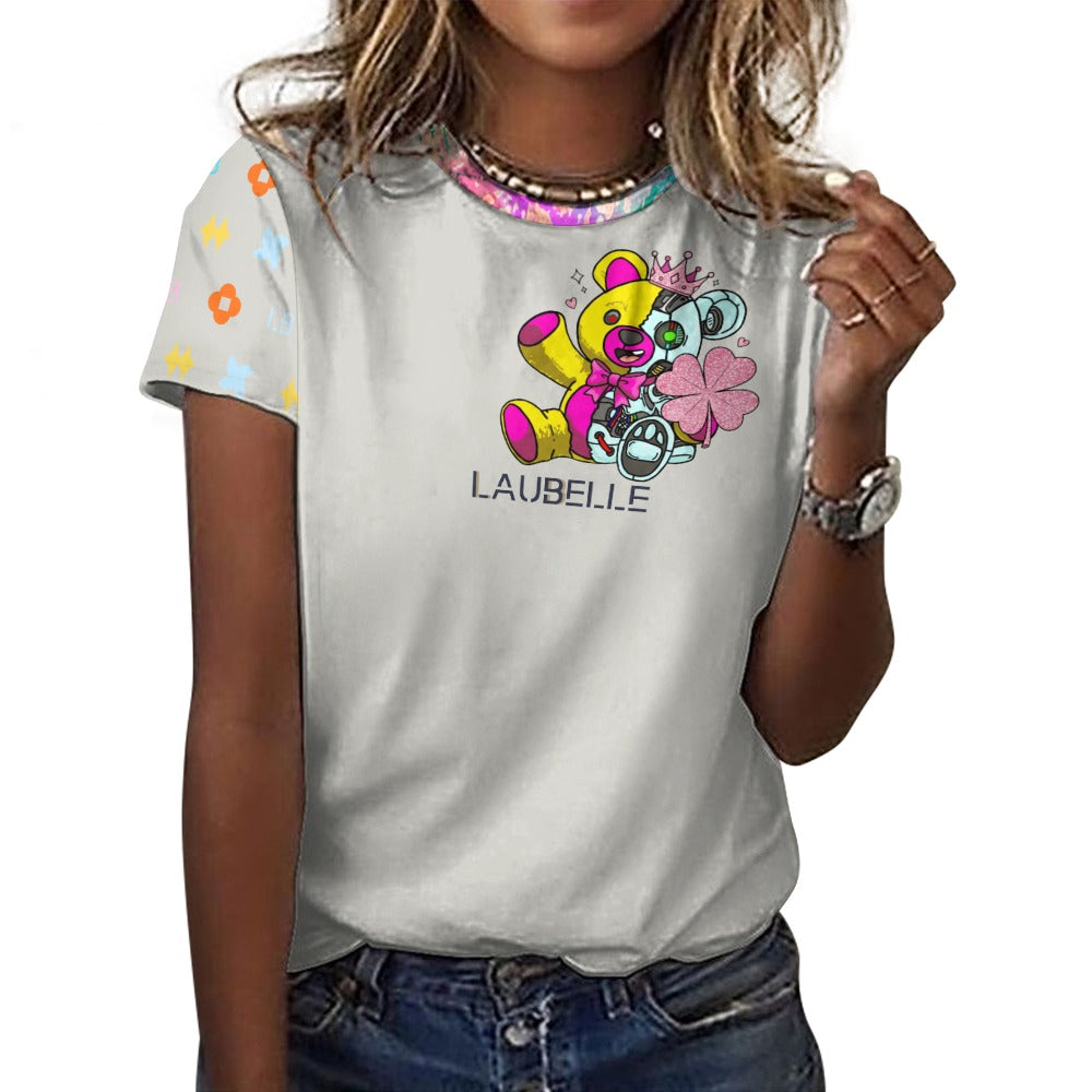 Woman in a white T-shirt with a colorful bear design and patterned sleeves, wearing jeans.