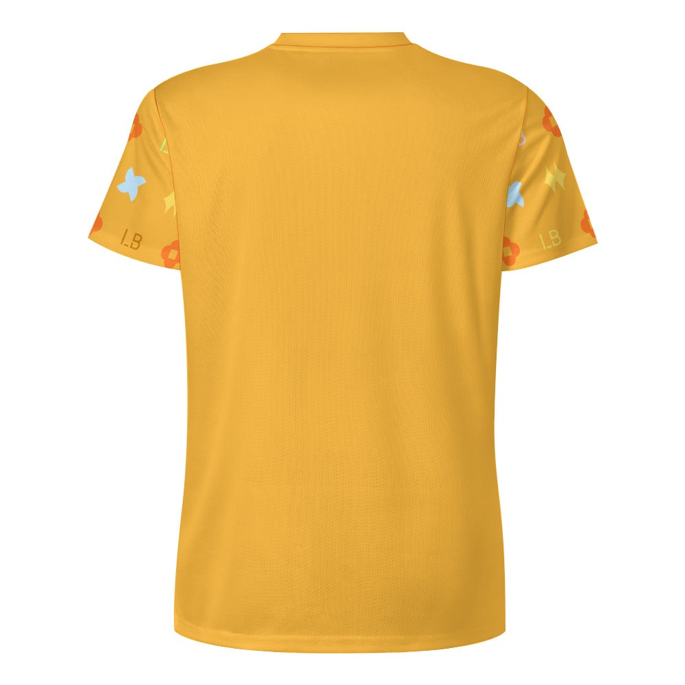 Back view of yellow T‑shirt with colorful geometric patterns on the short sleeves.