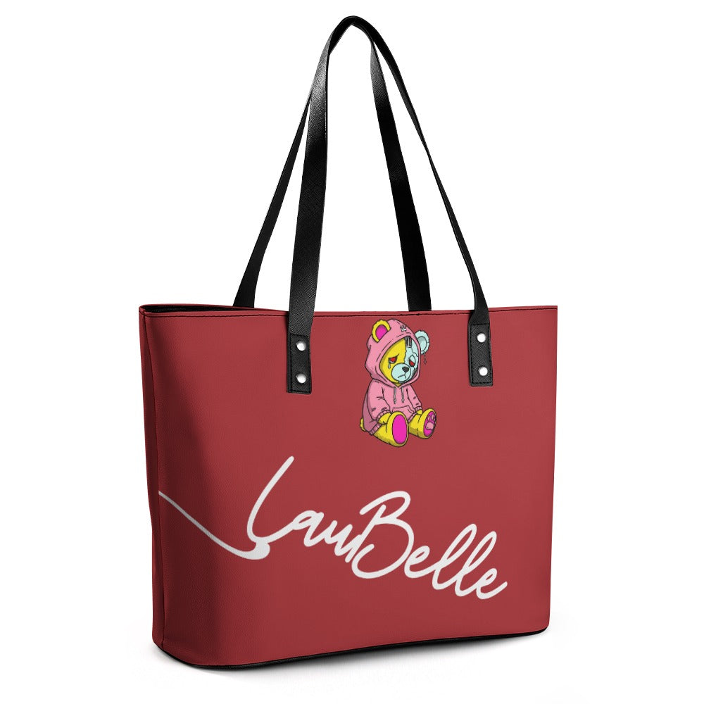 Red tote bag with black straps, featuring a bear in a hoodie and white "La Belle" text.