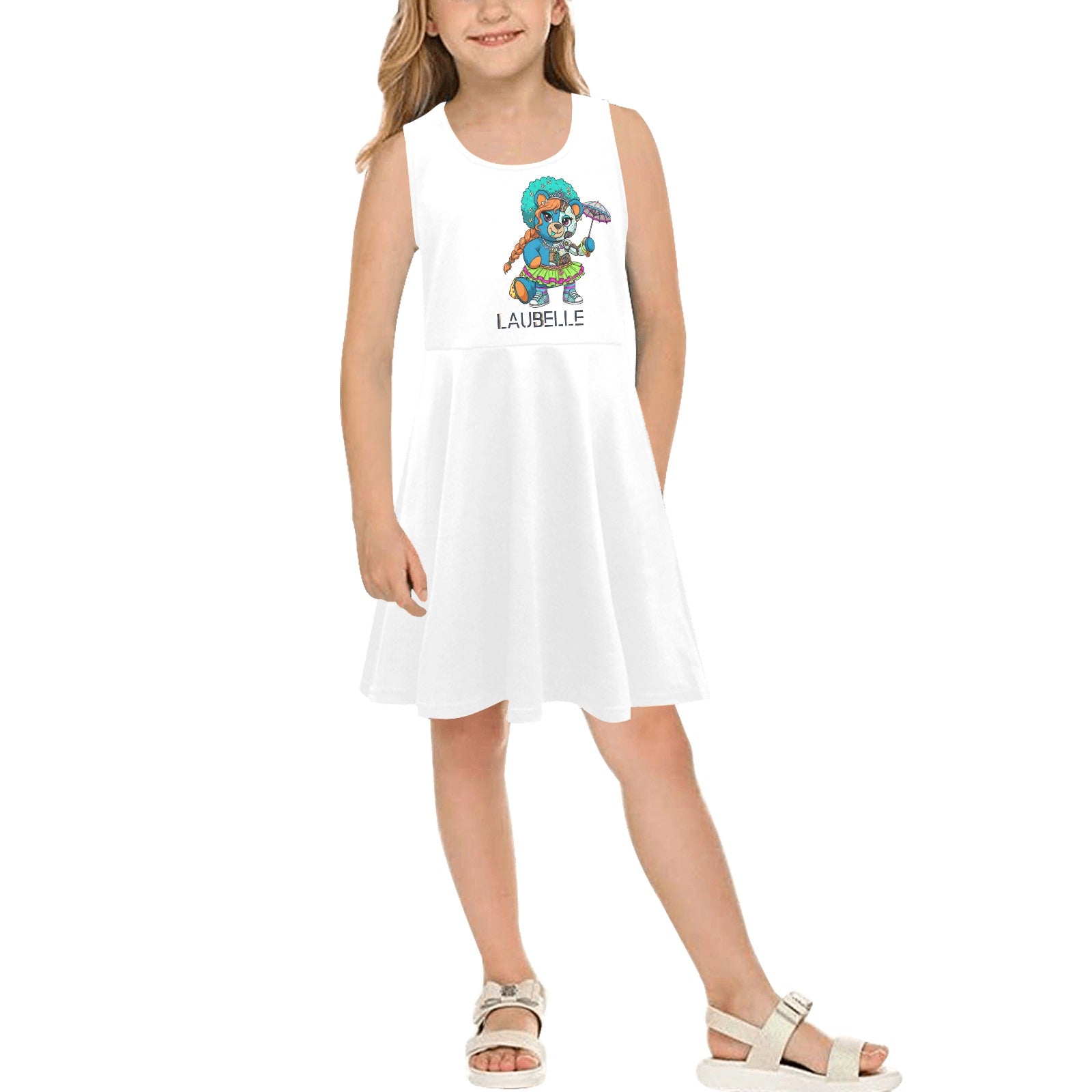 Young girl in a white dress with colorful cartoon print, standing and smiling, wearing sandals.