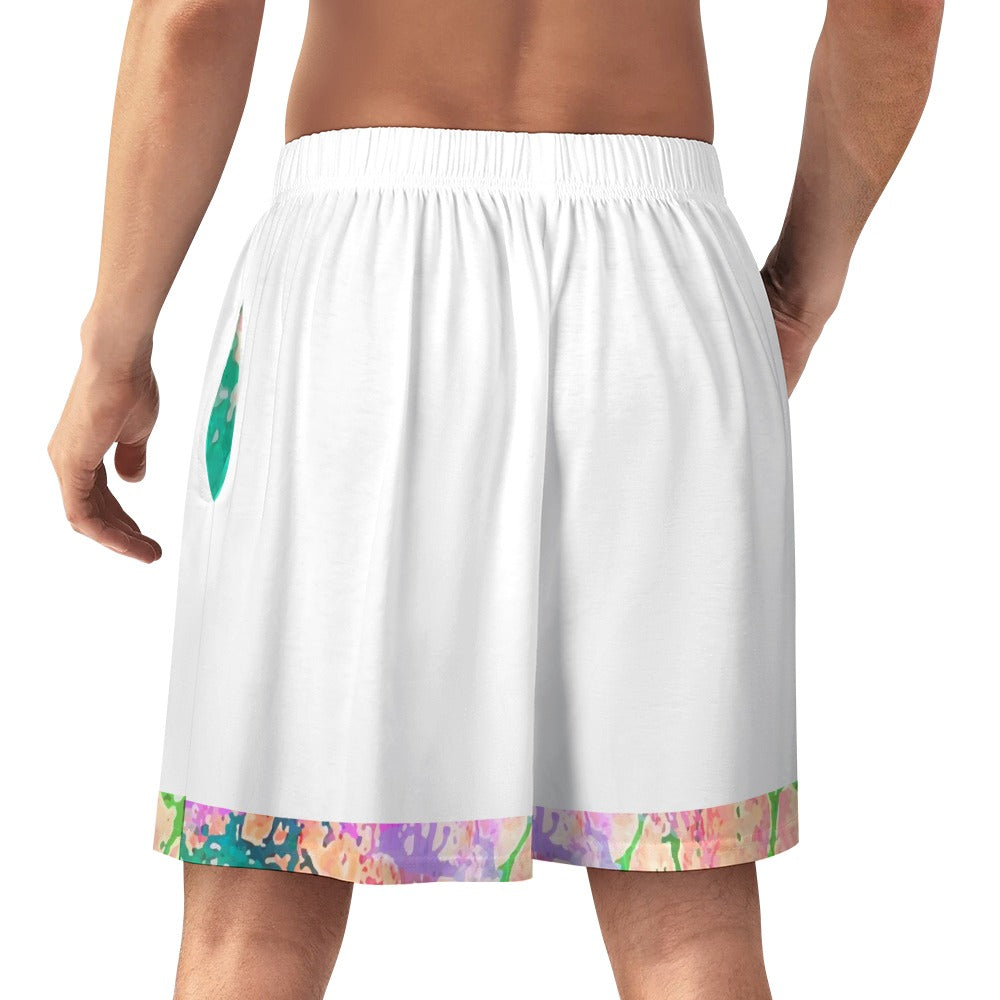 Man wearing white shorts with a colorful, abstract pattern on the hem.