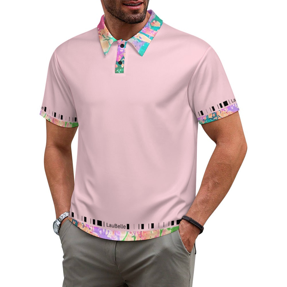 Man wearing a light pink polo with colorful floral collar and cuffs, hands in pockets.