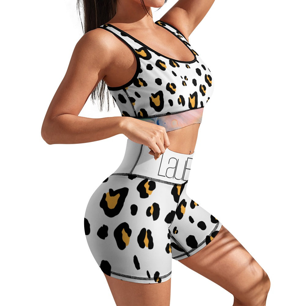 Woman wearing a white workout set with black and yellow leopard print, posing sideways.