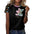 Woman in a black shirt with a colorful teddy bear graphic and patterned short sleeves.