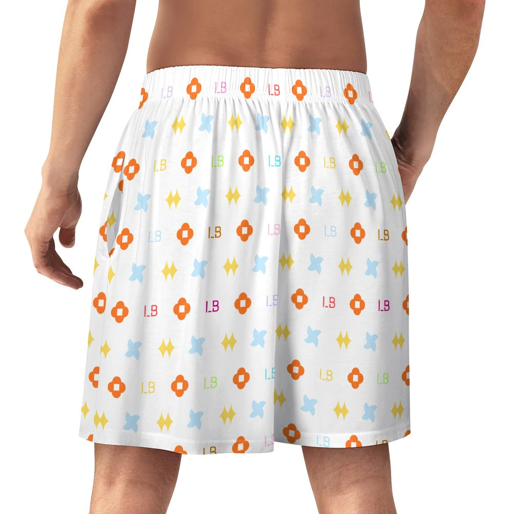 Man wearing white shorts with colorful geometric patterns in orange, blue, and yellow.