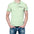 Man in light green polo shirt with colorful text on sleeves, blue jeans, and hands in pockets.