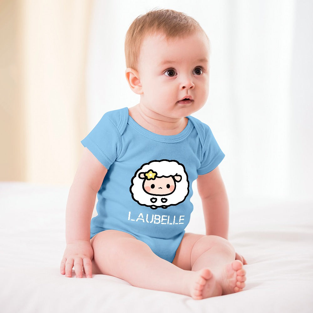 A baby in a blue onesie with a cartoon sheep and a yellow star sits on a white blanket.