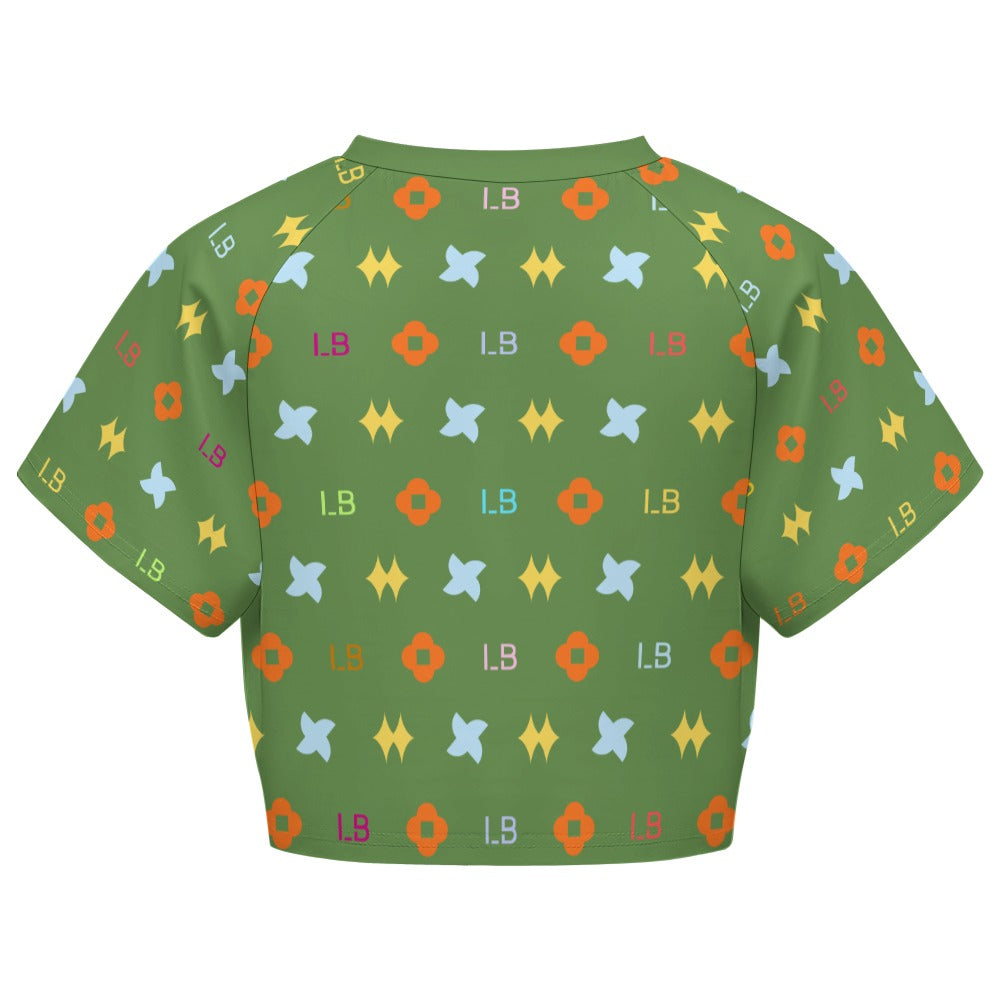 Green shirt with colorful geometric patterns including orange, yellow, and blue shapes.