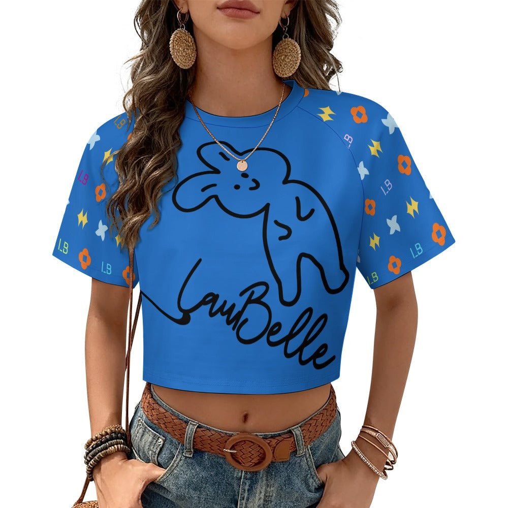 Woman in a blue crop top with a bunny design, colorful patterns, and wearing denim shorts.