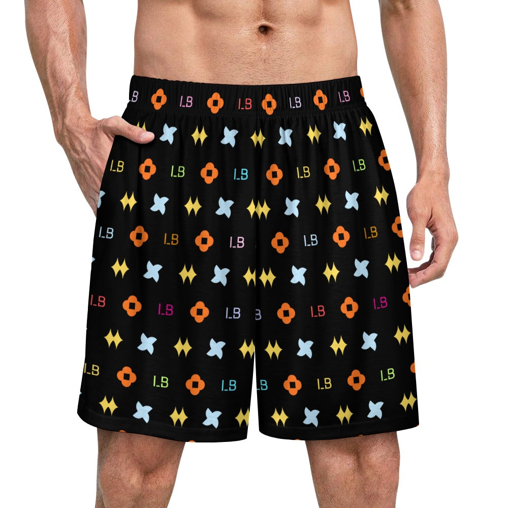 Man wearing black shorts with colorful geometric and letter patterns.