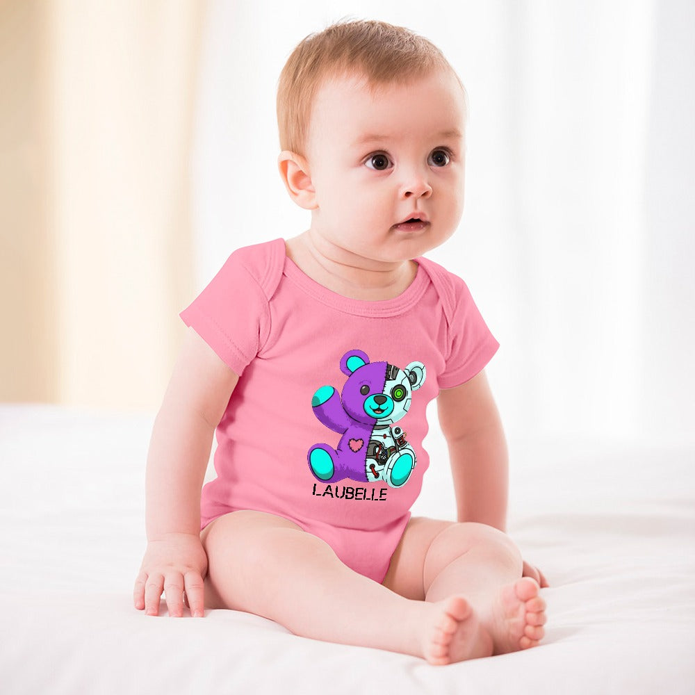 Baby in a pink onesie with a colorful teddy bear design, sitting on a white blanket.