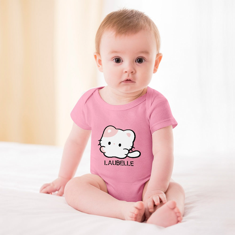Baby in a pink onesie with a cute cartoon cat design, sitting on a white blanket.