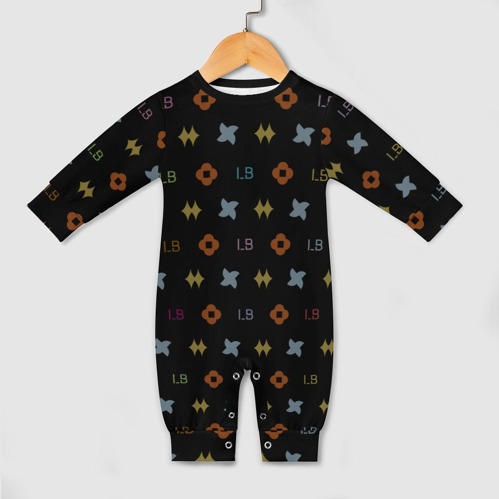 Black baby jumpsuit with colorful geometric shapes and letters, hanging on a wooden hanger.
