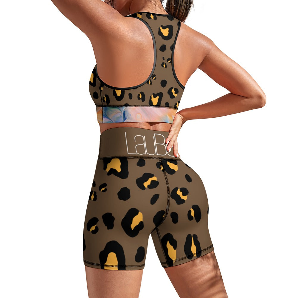 Woman in leopard print workout set, brown and black pattern, hands on hips, white background.