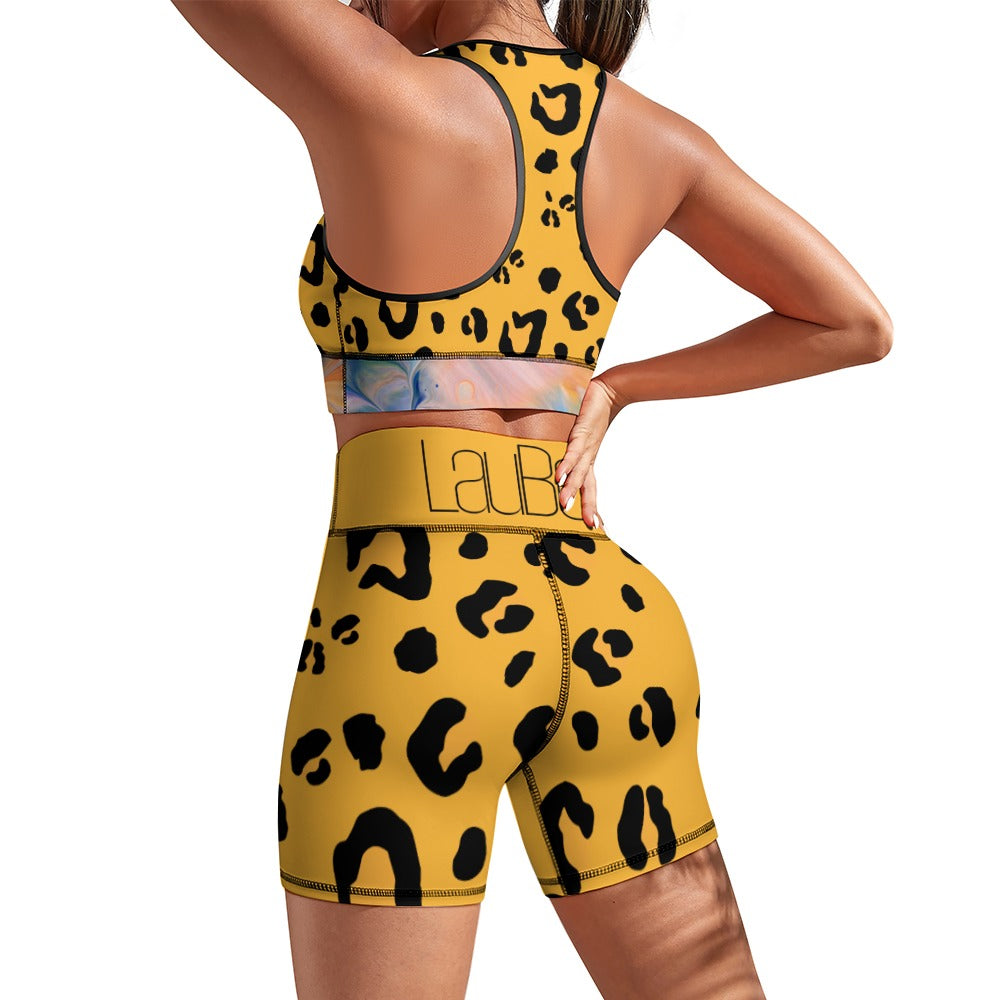 Woman in yellow leopard-print workout set, back view, hands on hips.