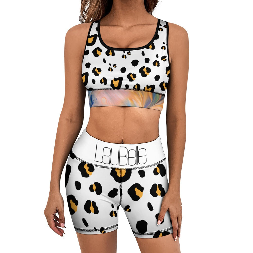 Woman wearing a leopard print sports outfit with a black-trimmed crop top and matching shorts.