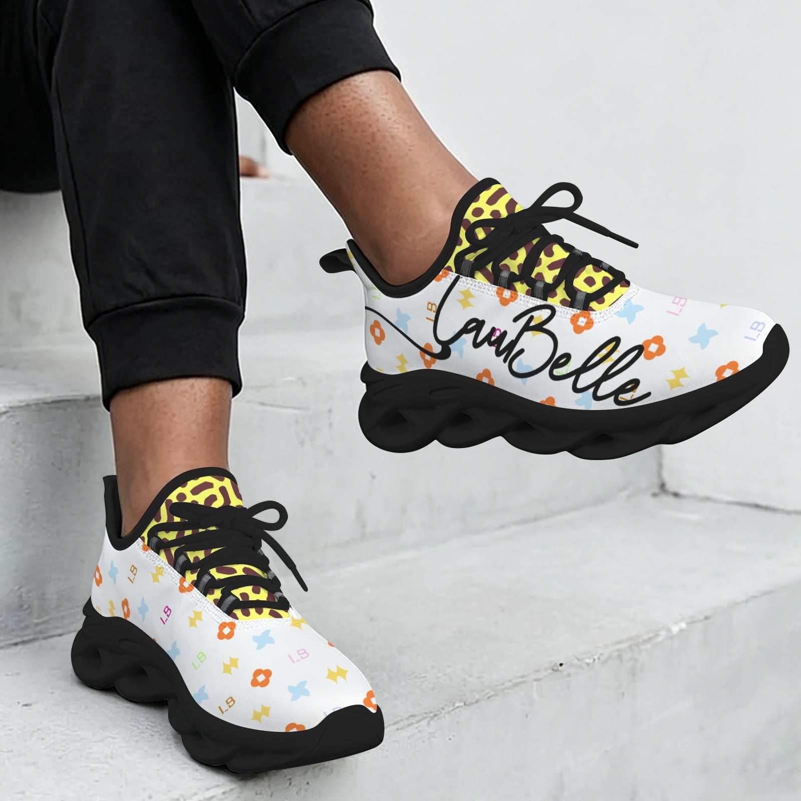 White sneakers with colorful patterns, black soles, and the word "LaBelle" written on the side.