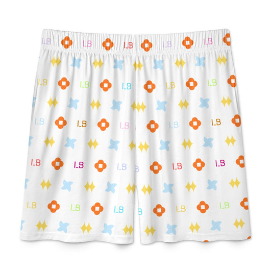 White shorts with a colorful pattern of orange, blue, yellow shapes, and letters on fabric.