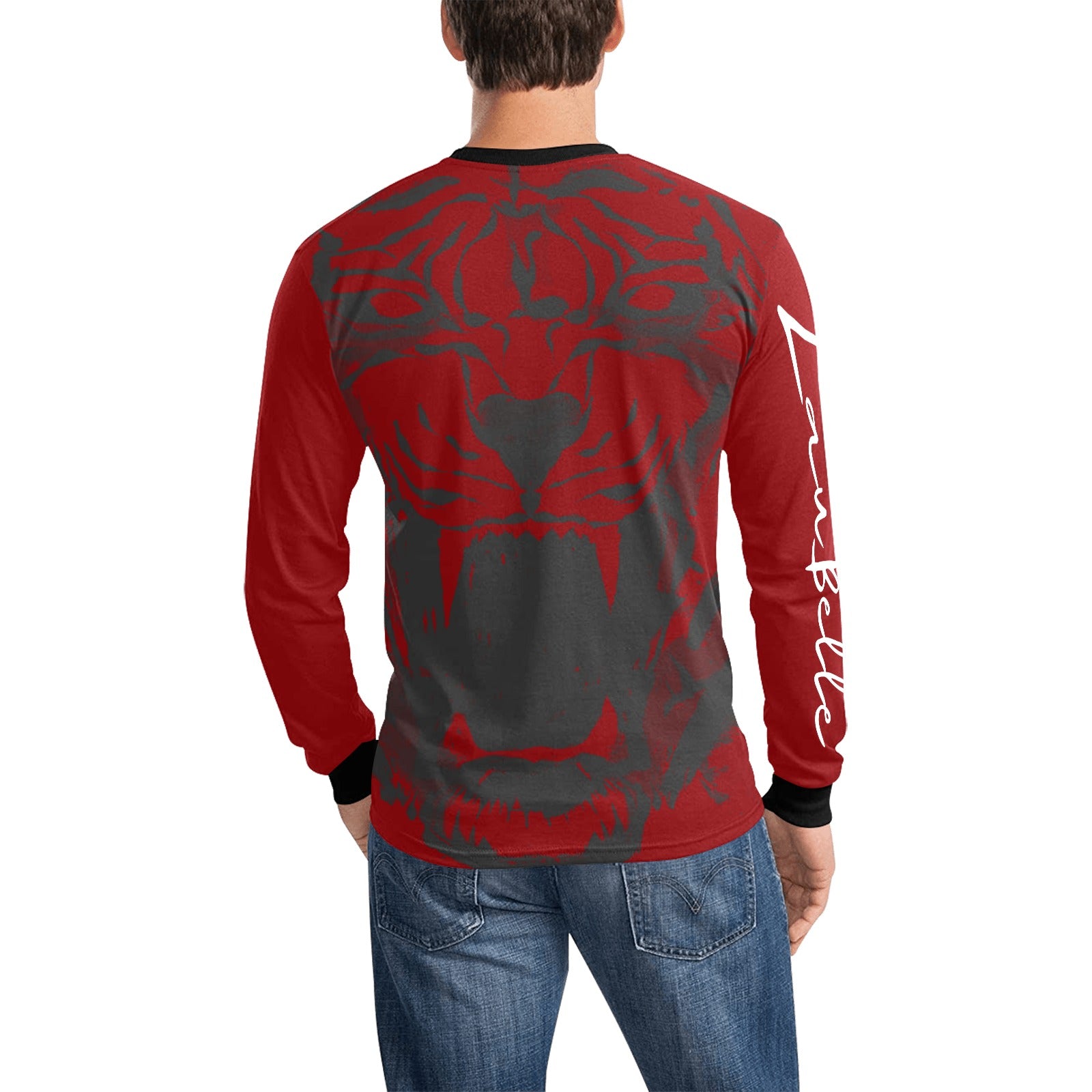 Man in red and gray shirt with lion face, white text on sleeve, wearing blue jeans.