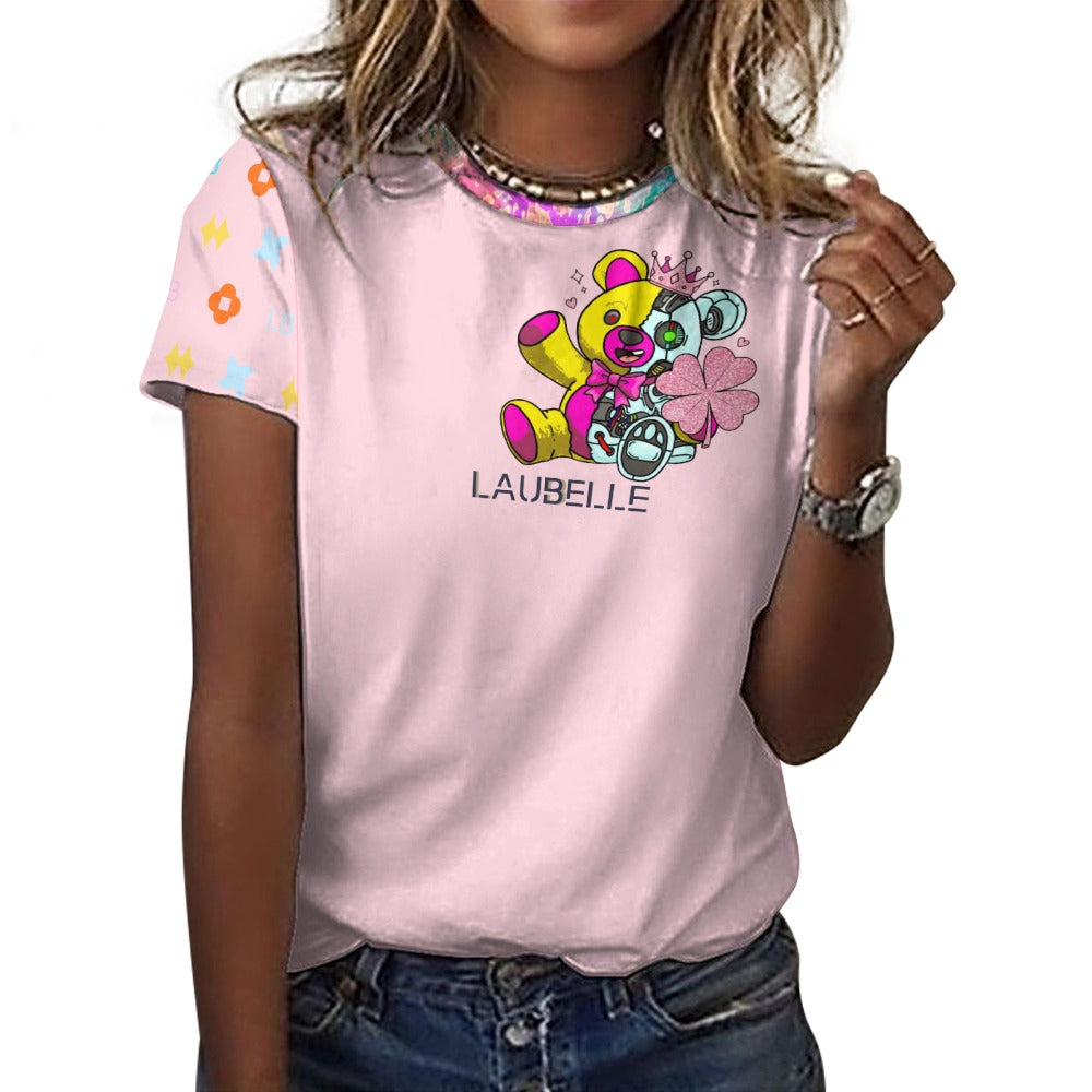 Woman in a pink shirt with colorful bear graphic, patterned sleeves, and jeans.
