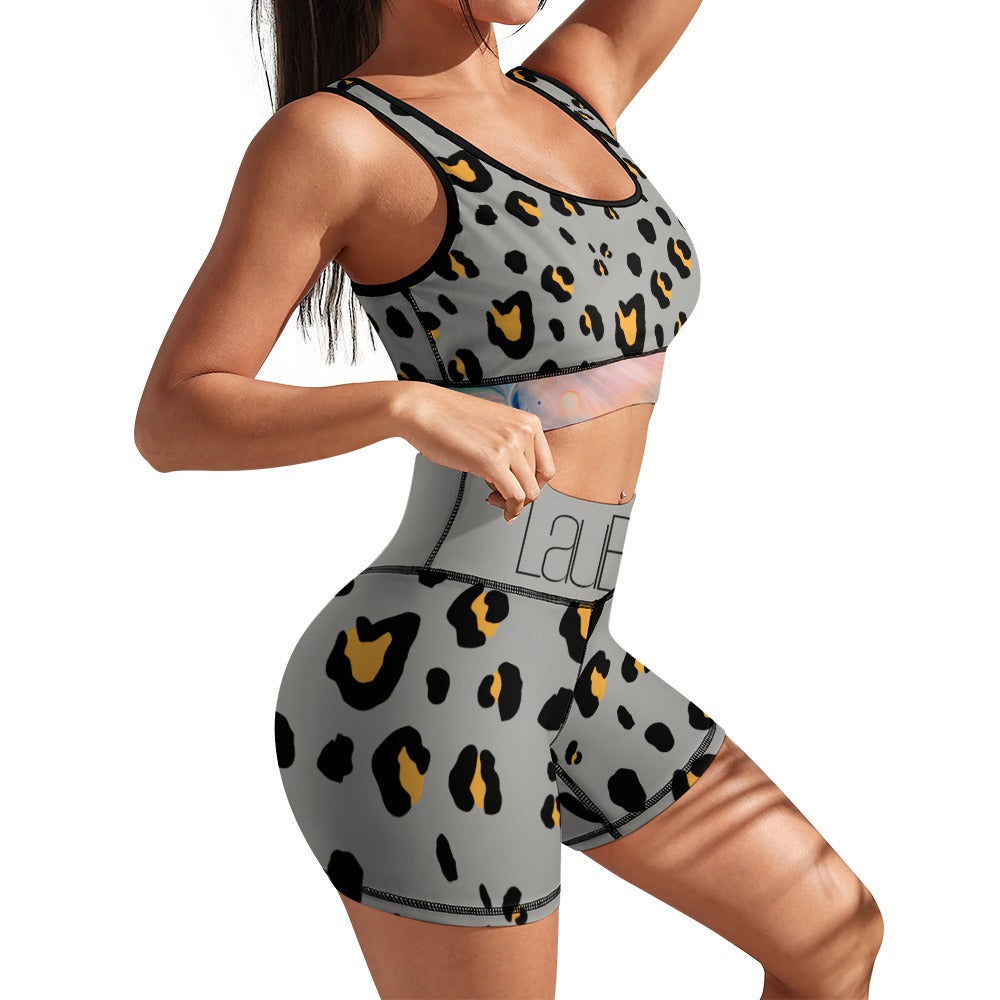 Woman in gray leopard-print workout set, standing in a side pose with her arms bent.