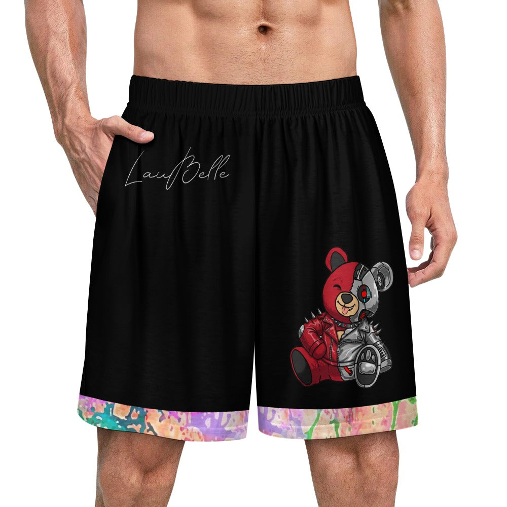 Man wearing black shorts with a colorful teddy bear design and a paint-splatter pattern on the hem.