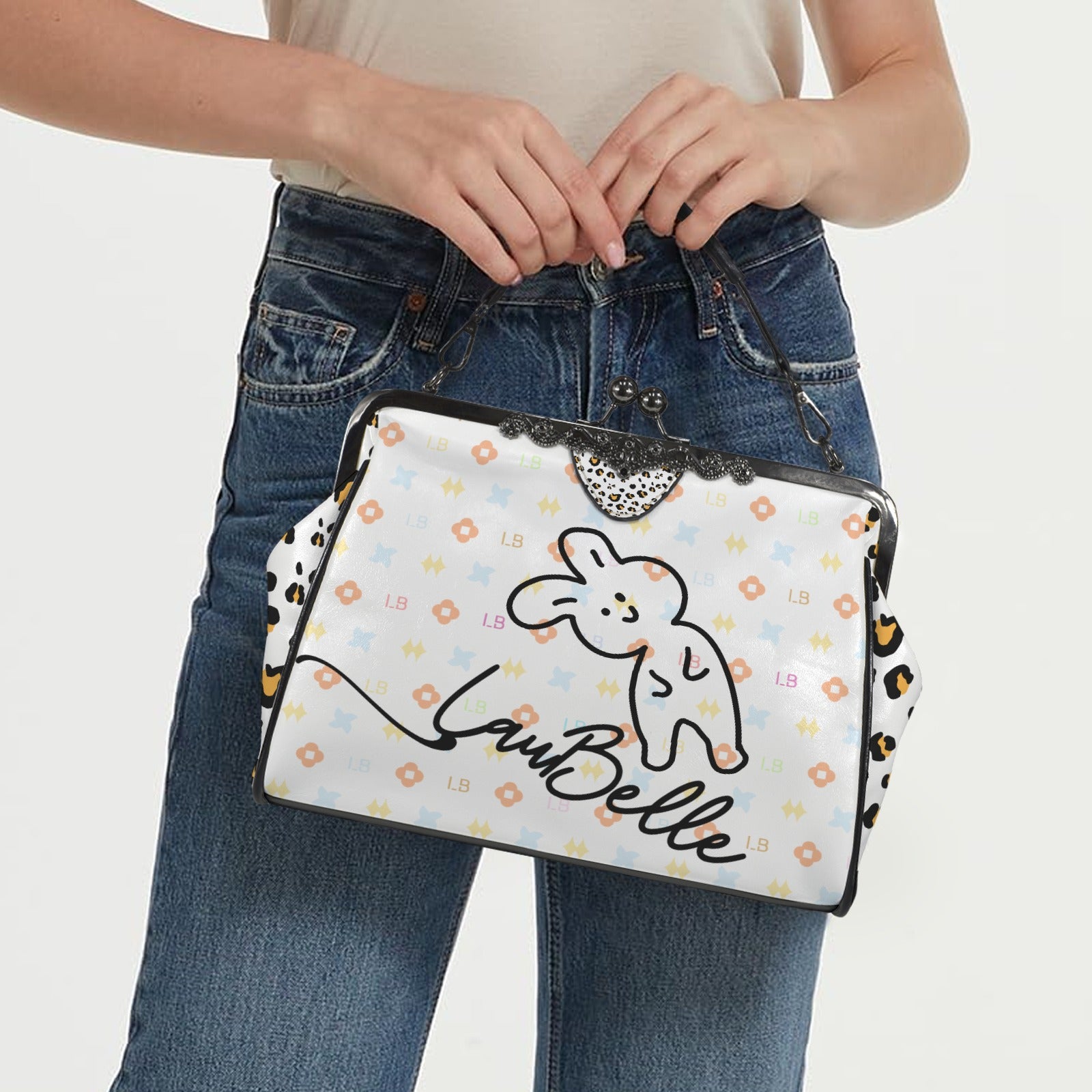 Woman holding a white handbag with a cute bunny design, orange patterns, and black text.