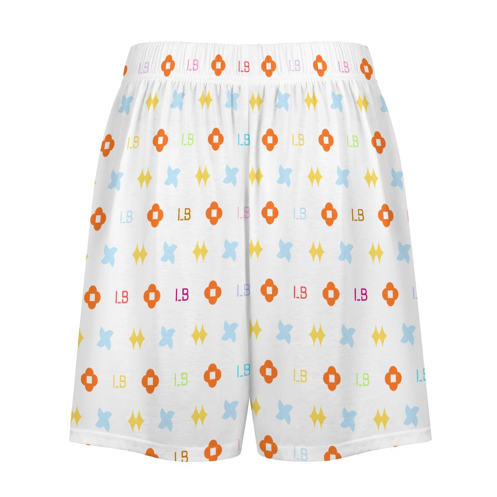 White shorts with colorful geometric patterns and letters in orange, blue, yellow, and red.