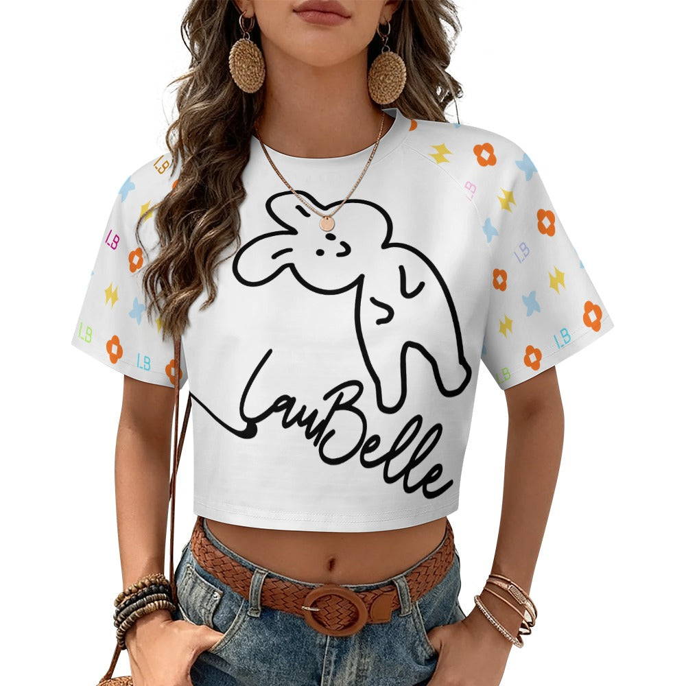 Woman in a white crop top with a cartoon rabbit and patterns, wearing jeans and hoop earrings.