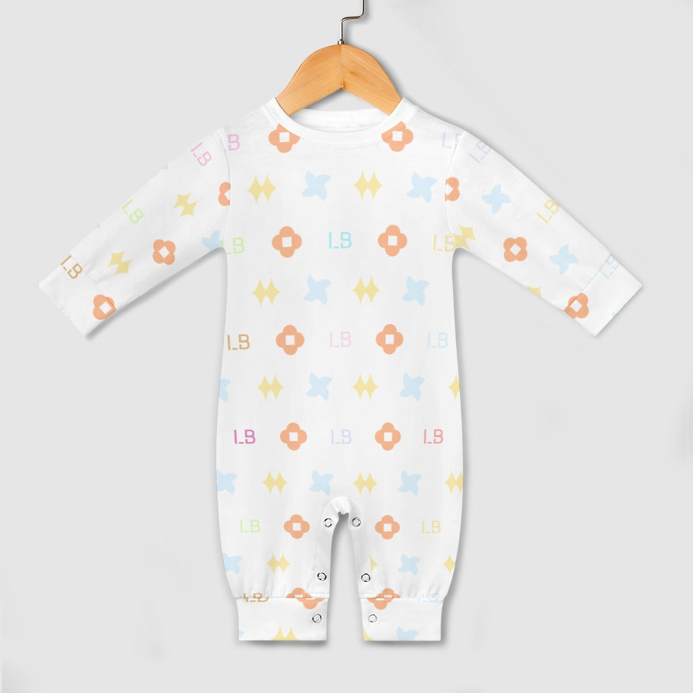 White baby onesie with colorful geometric patterns on a wooden hanger against a gray background.