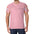Man in pink T‑shirt with cursive logo and colorful floral sleeves, wearing dark jeans.